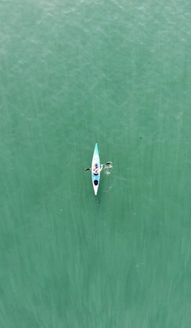 a person in a kayak in the middle of a body of water