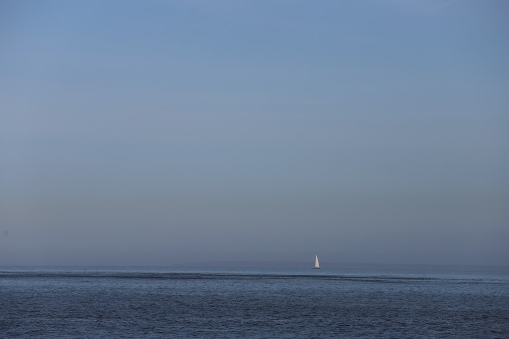 a sailboat is out on the open water