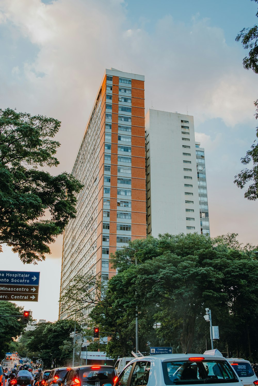 a city street filled with traffic next to tall buildings