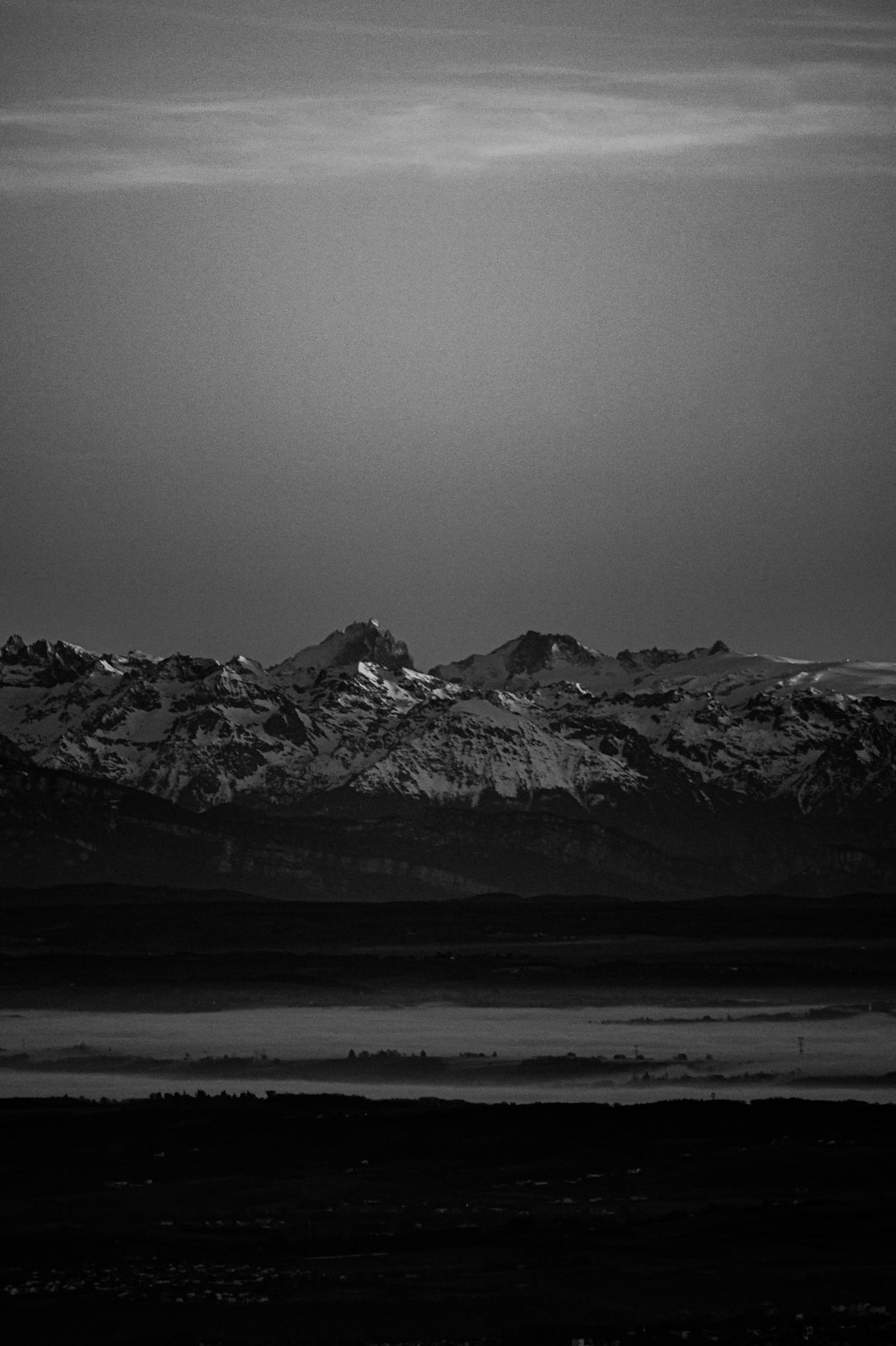 a black and white photo of a mountain range