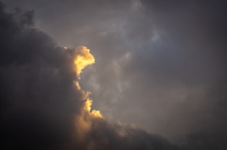 a plane flying in the sky with a lot of clouds