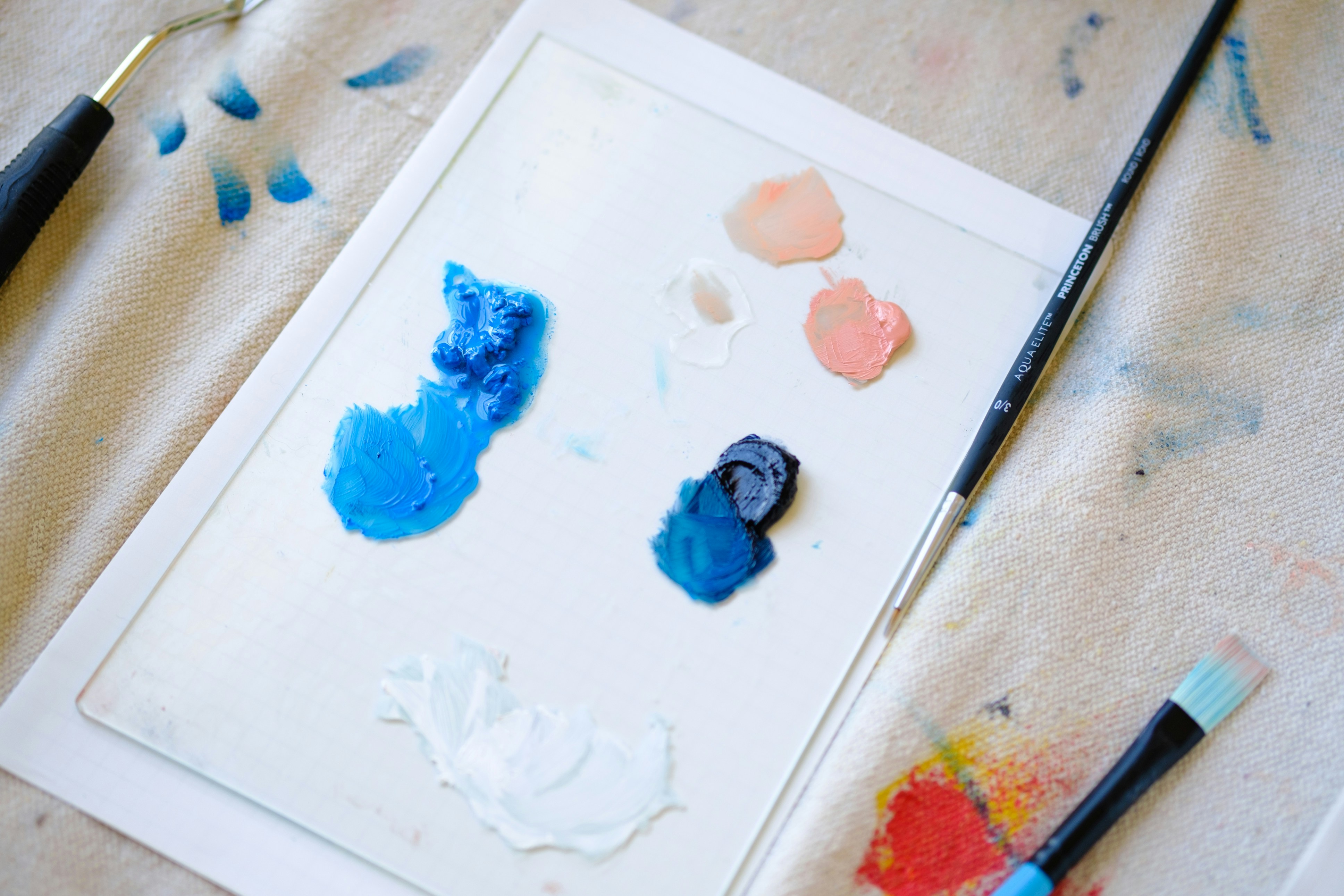 Paint and brush on table