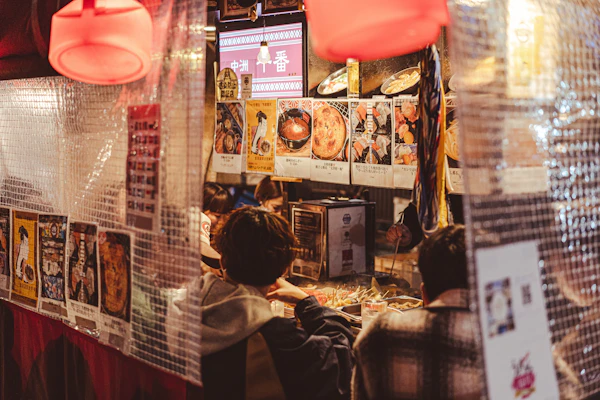 A yatai food stall lit up at night in Fukuoka's Nakasu district