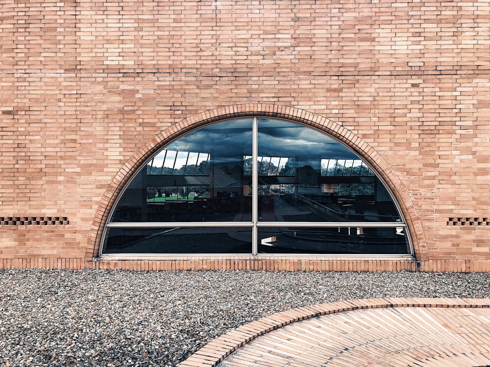 Un bâtiment en brique avec une grande fenêtre cintrée photo – Photo Cambre  Gratuite sur Unsplash