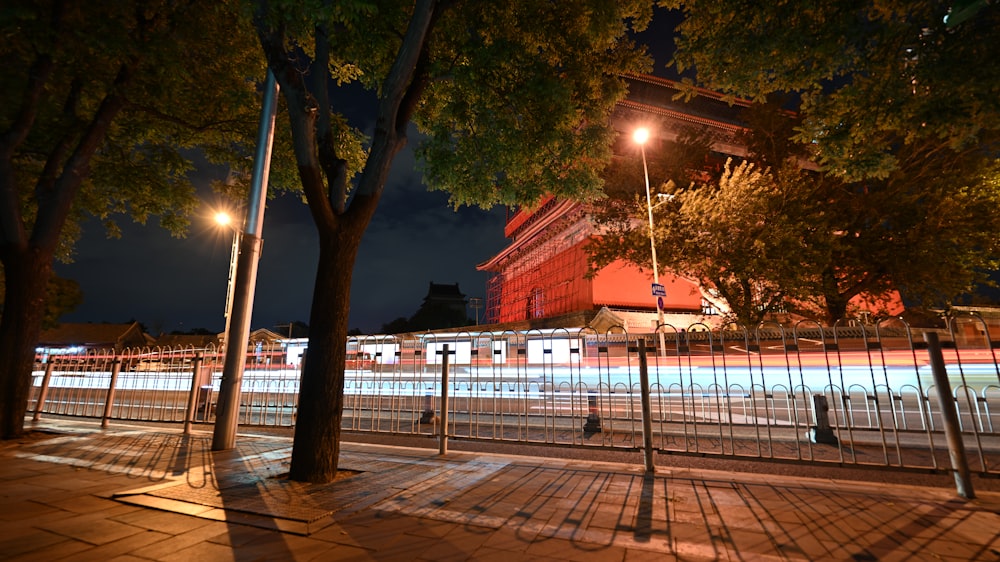 a night view of a city street with a building in the background