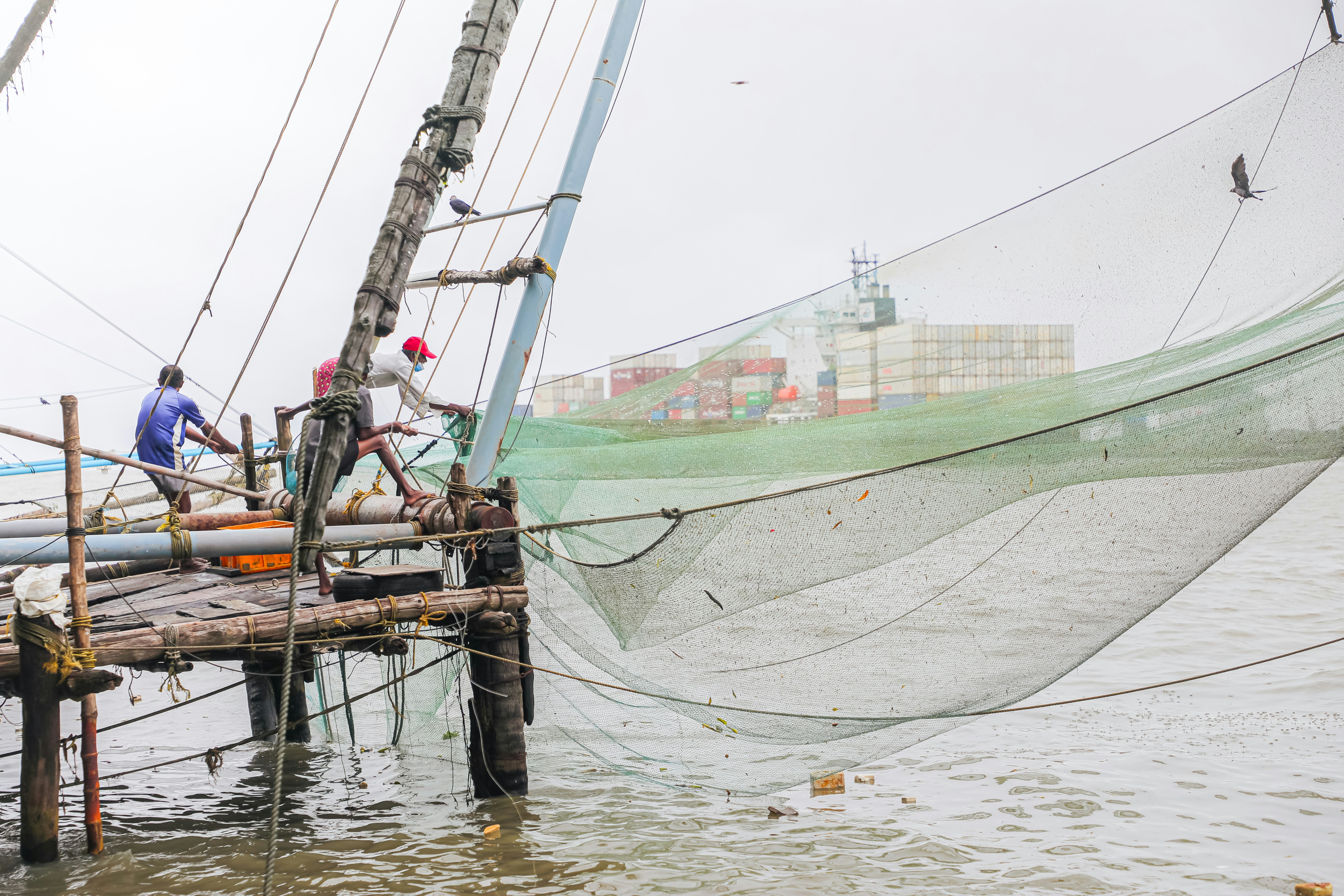 a group of men standing on top of a boat