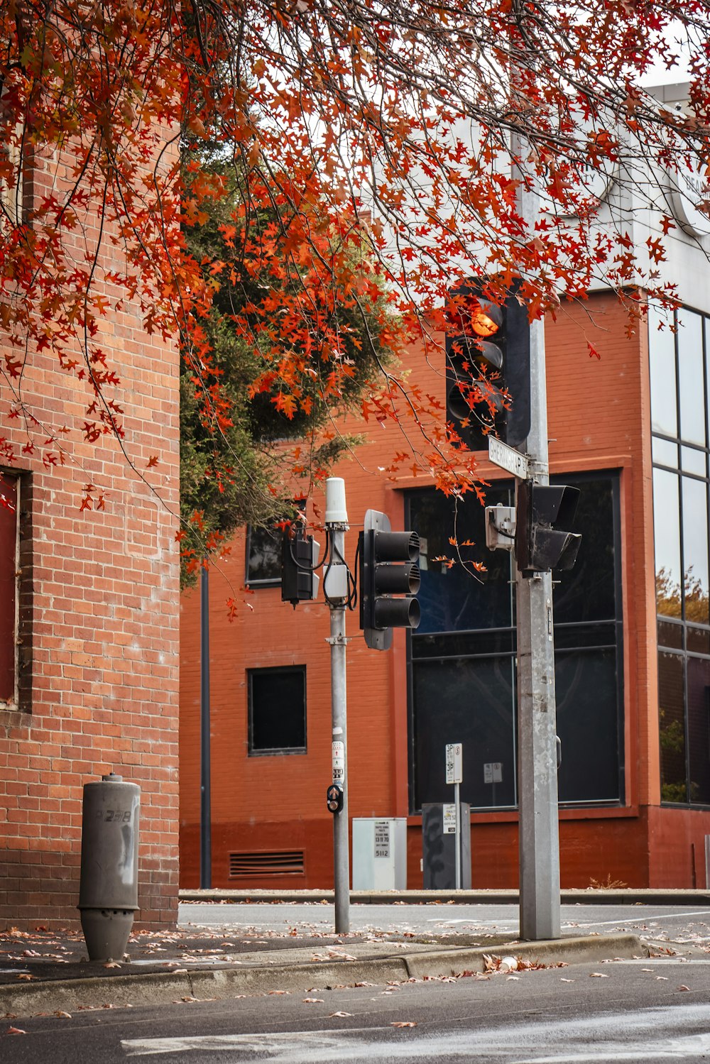 a street light sitting next to a tall brick building