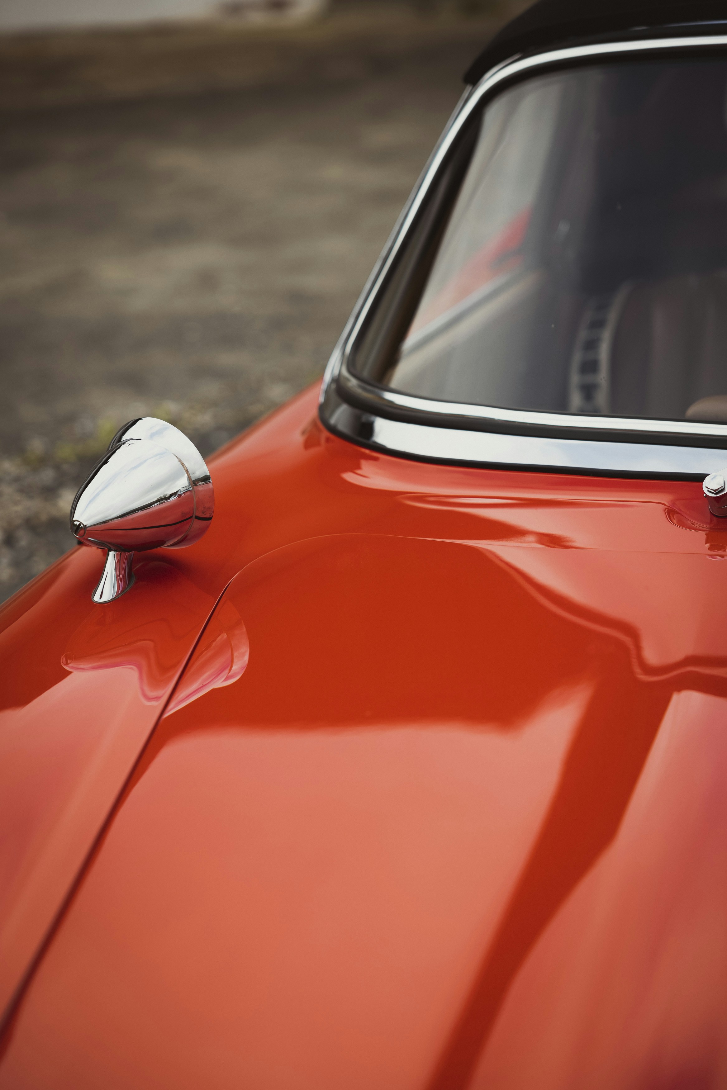 a close up of a red car with a black roof