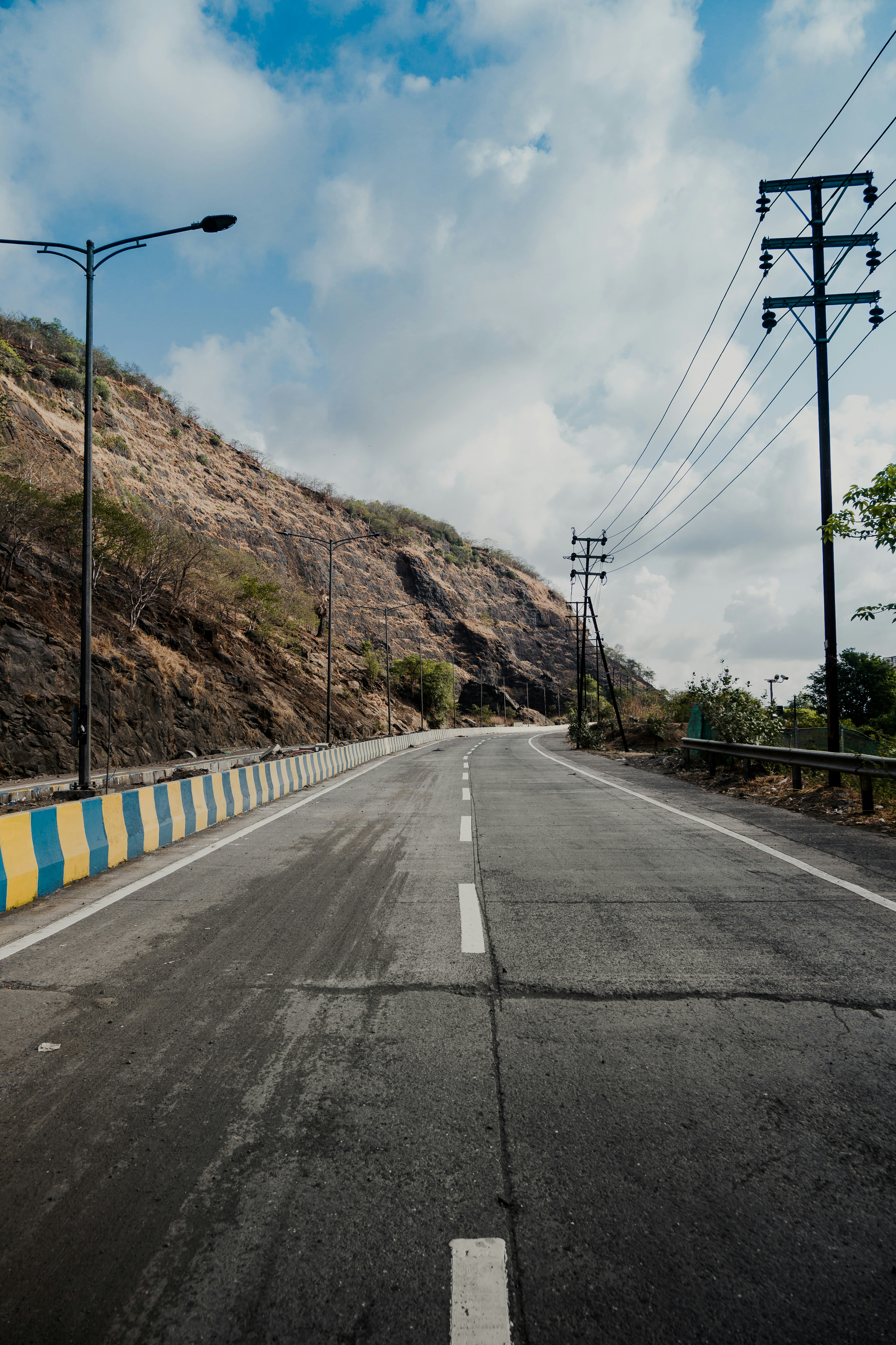 an empty road with a mountain in the background