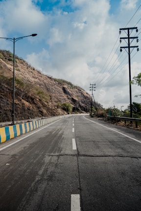 An infrastructure project featuring a newly paved road with safety barriers and smooth asphalt.