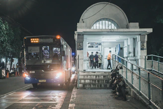 An AccessRide vehicle arriving at a social services center with passengers boarding.