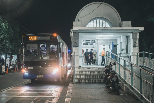 City buses with carsafe™ devices installed, passengers boarding safely at a busy urban stop.