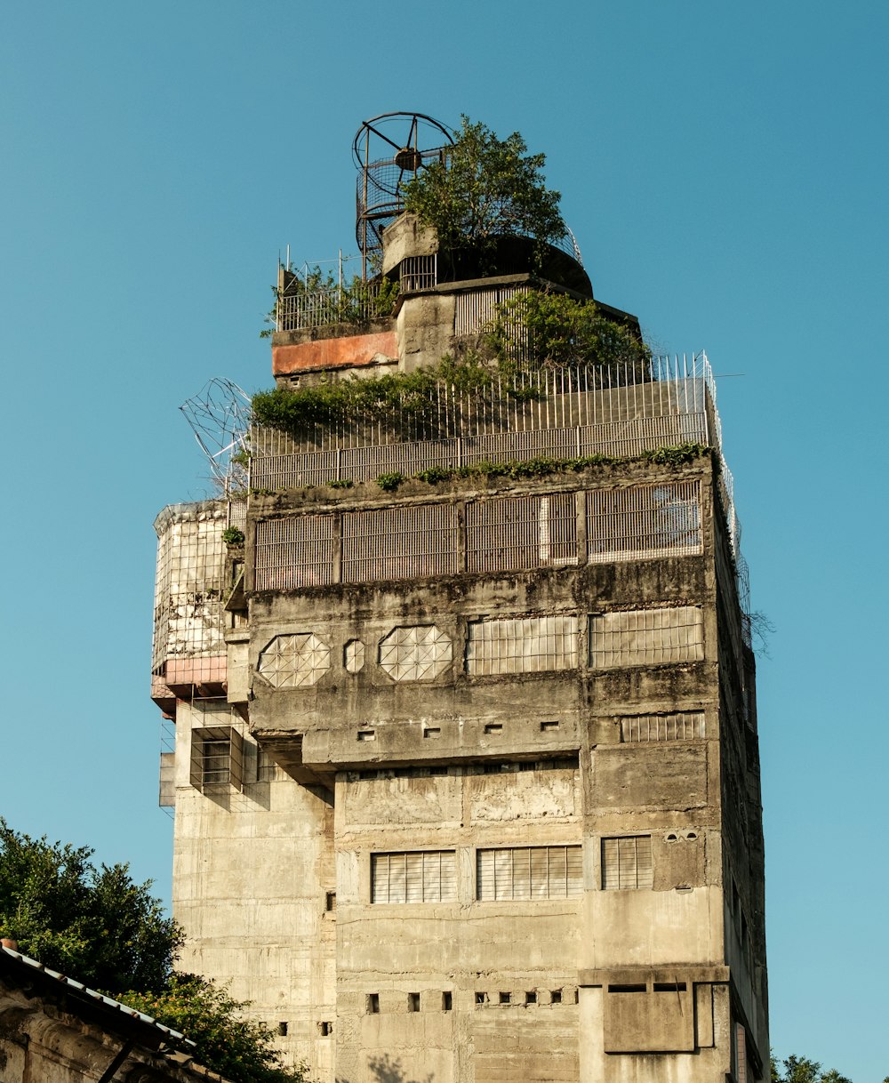 a tall building with plants growing on the top of it