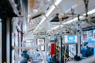 Interior shot of a bus with multiple LED screens showing different ads to passengers.