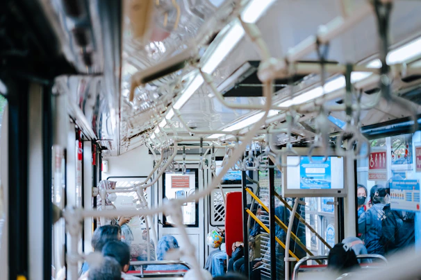 Interior shot of a bus with multiple LED screens showing different ads to passengers.