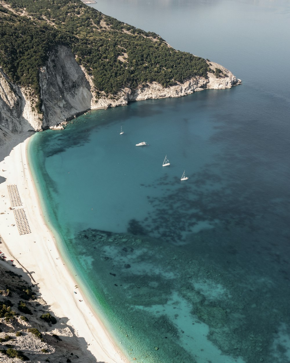 a view of a beach with boats in the water