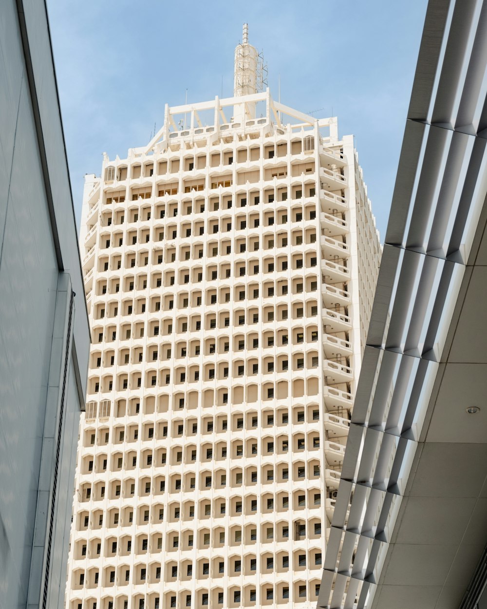 a tall white building with a clock on it's side