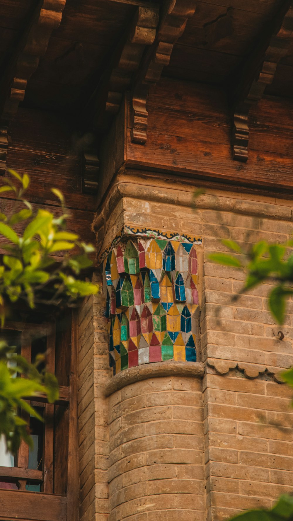 a decorative window on the side of a brick building