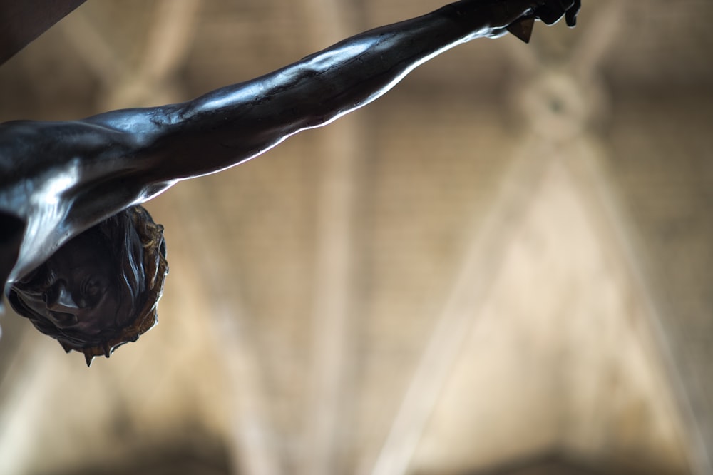 a close up of a statue of a man with his arm outstretched