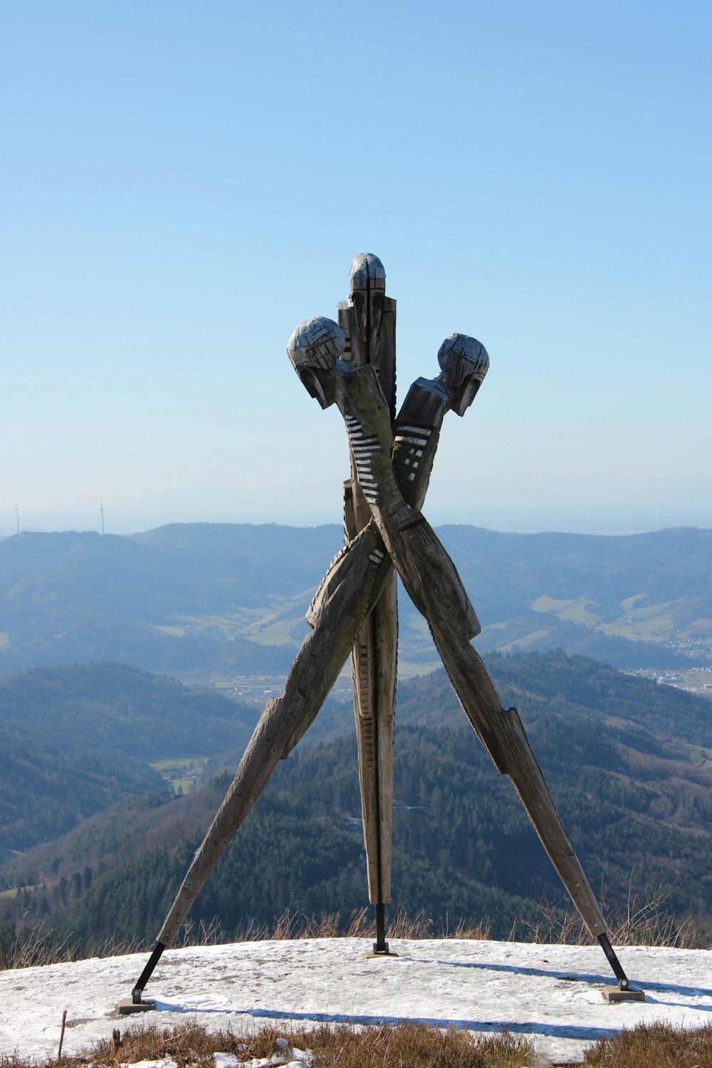 a sculpture of a pair of legs on top of a mountain