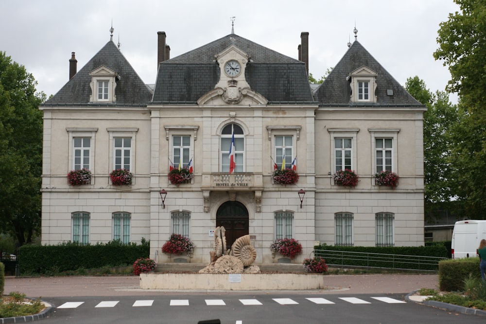 a large building with a fountain in front of it