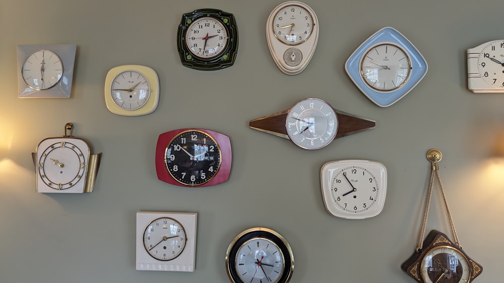 a wall with many different clocks on it
