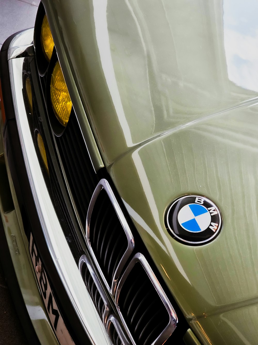 a close up of the front of a green bmw car