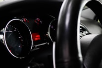 Close-up of a car dashboard showing mileage and VIN sticker.