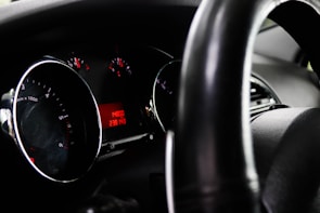 Close-up of a car dashboard showing mileage and condition.