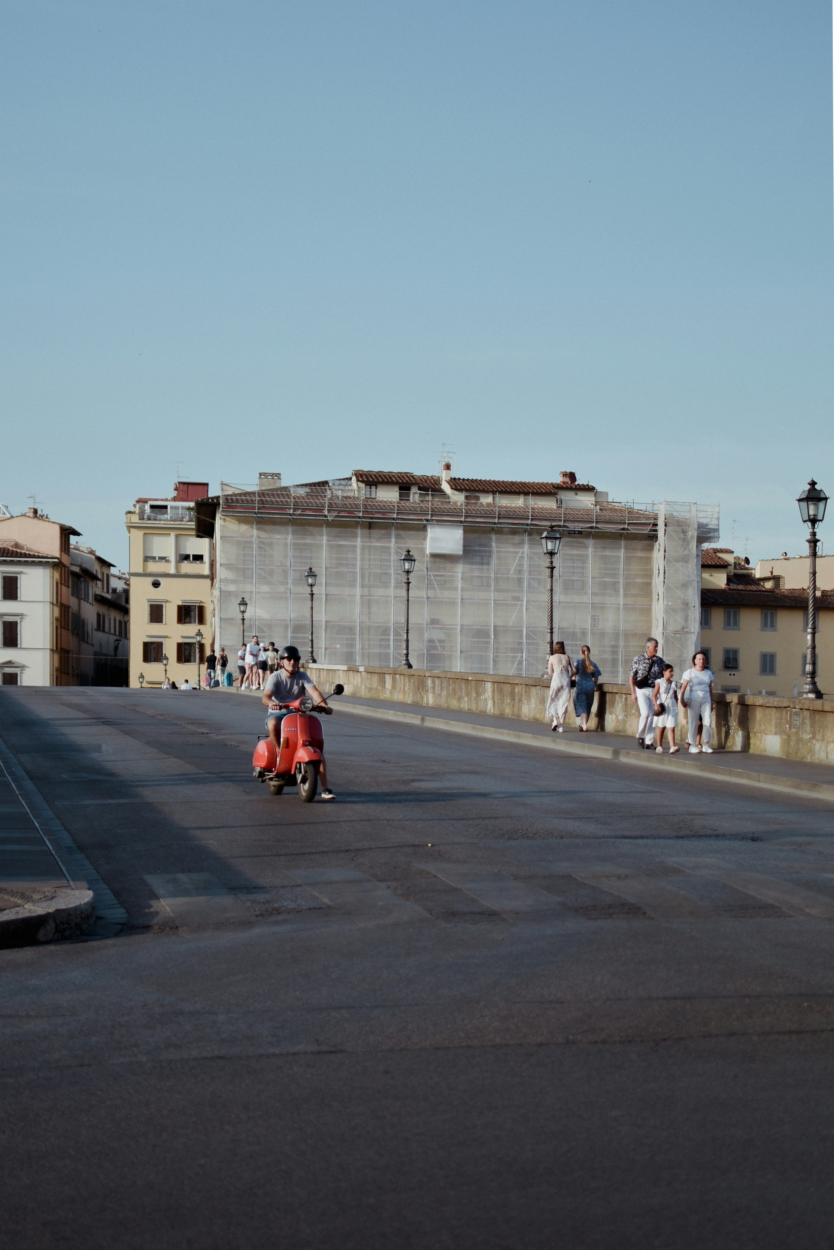 a group of people walking across a bridge