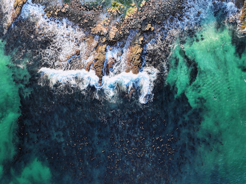 a bird's eye view of the ocean and rocks