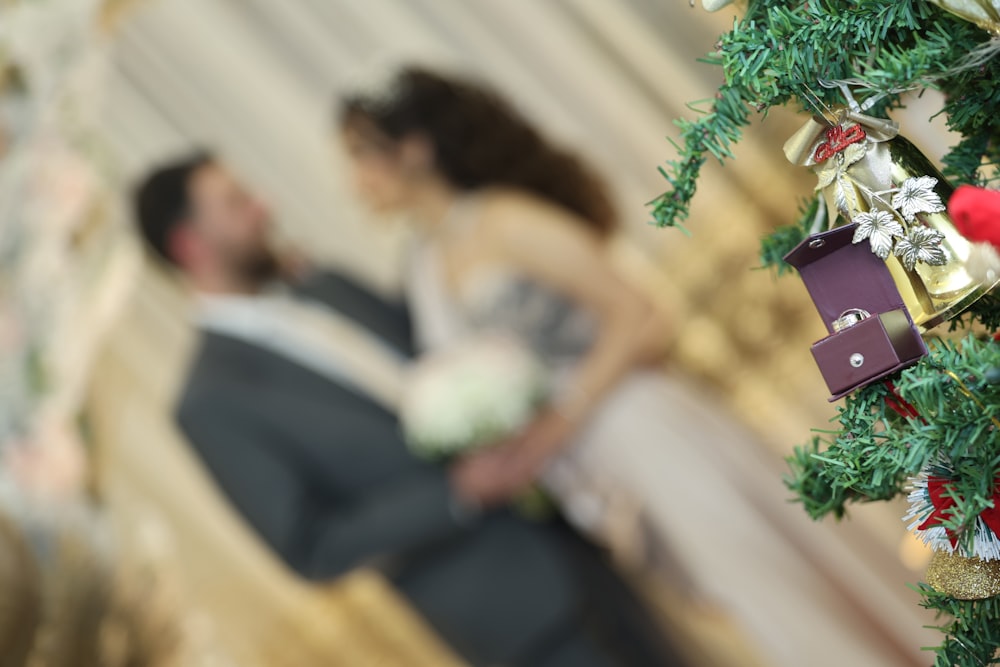 a bride and groom standing next to a christmas tree