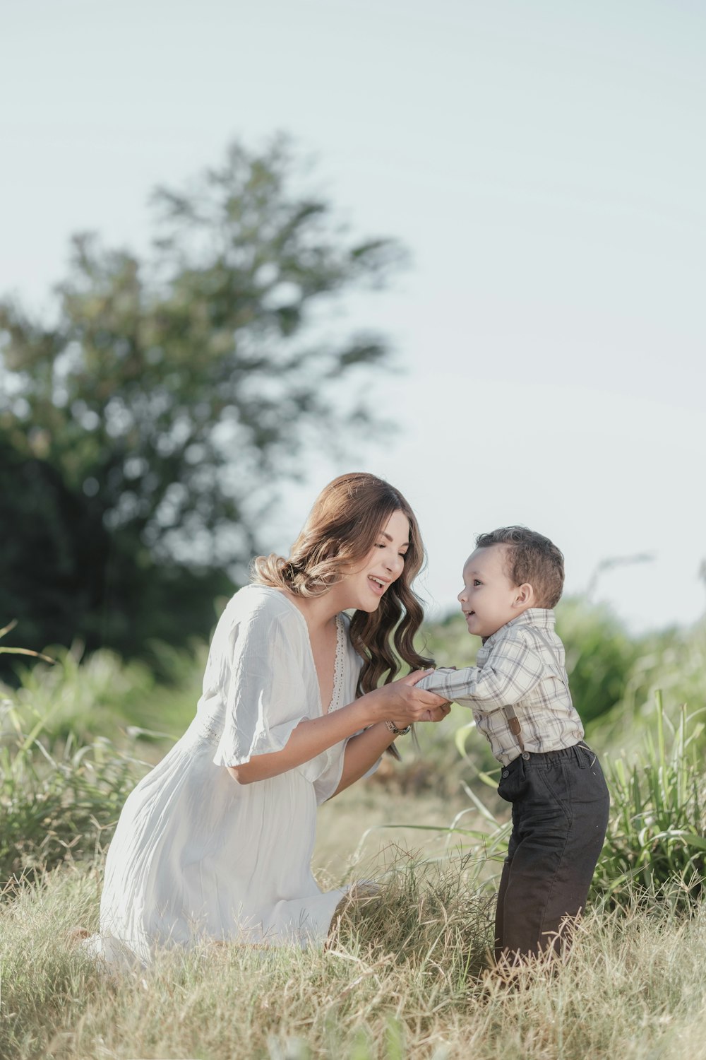 a mother and son playing in a field