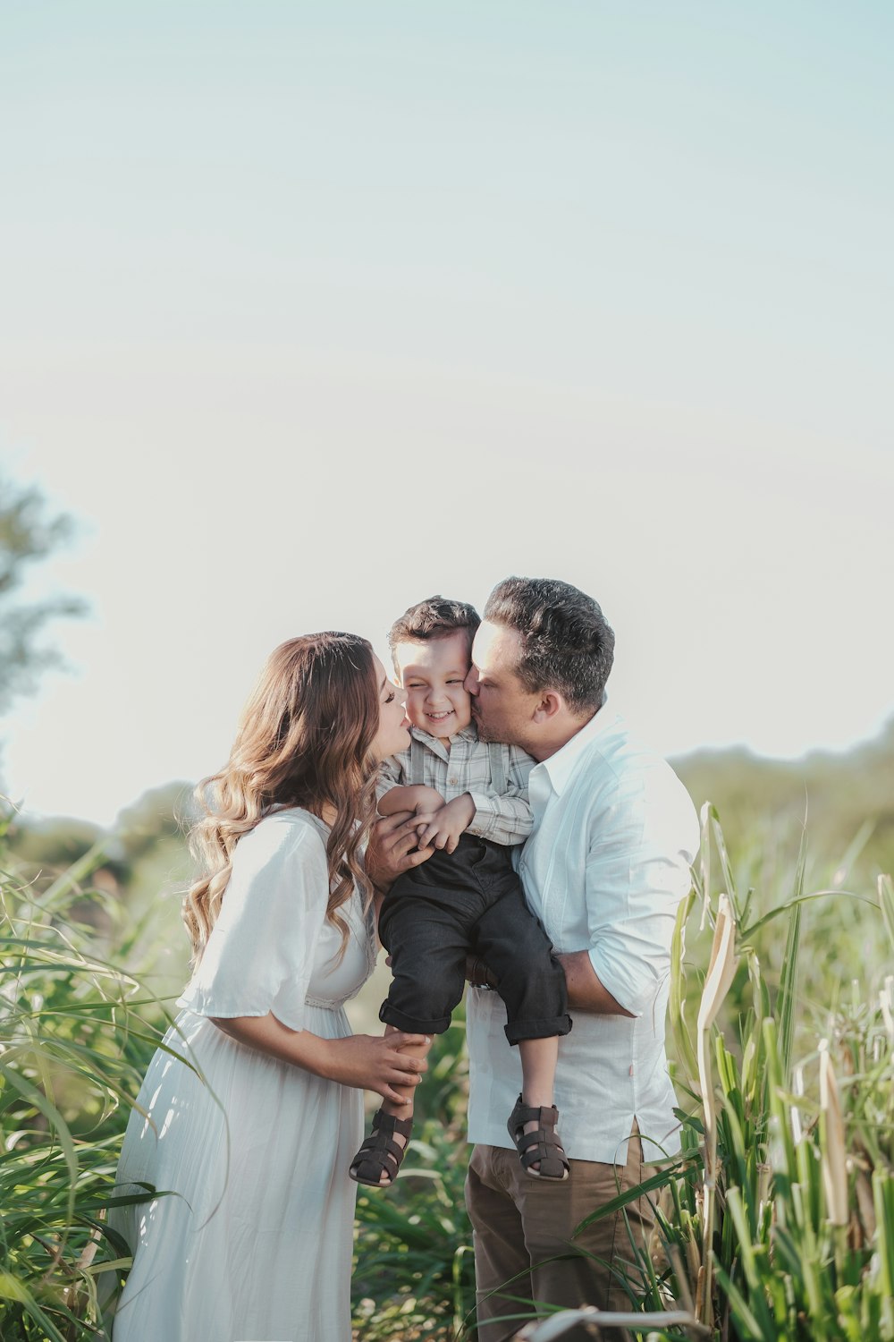 a family standing in a field of tall grass