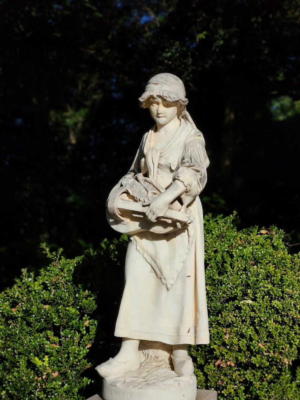 a statue of a woman holding a bird in her hands
