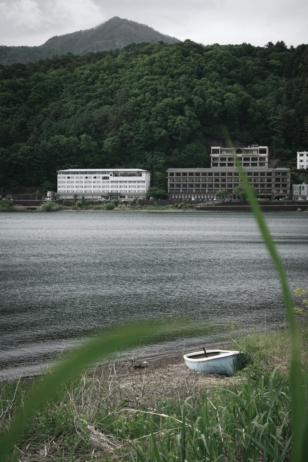 a boat sitting on the shore of a lake