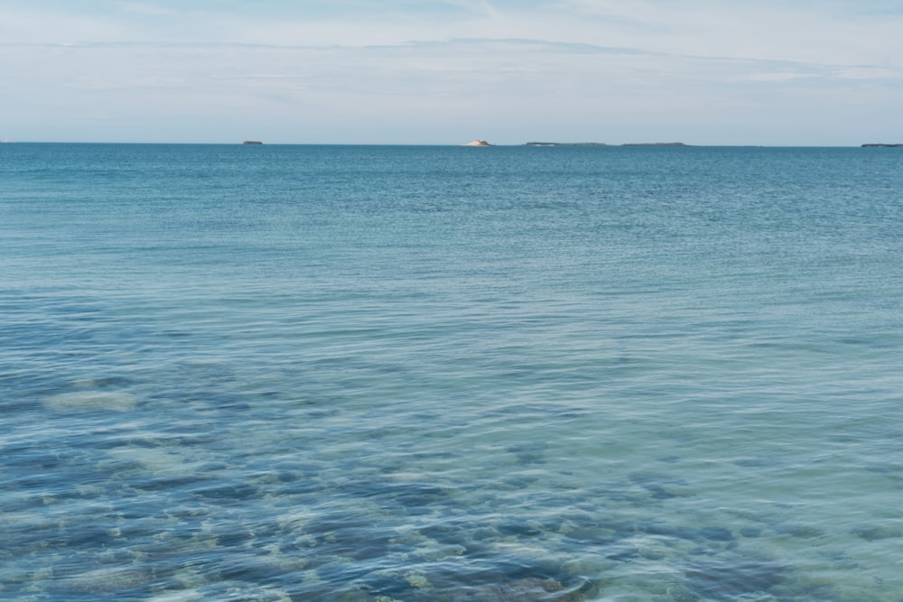 a large body of water with a small island in the distance