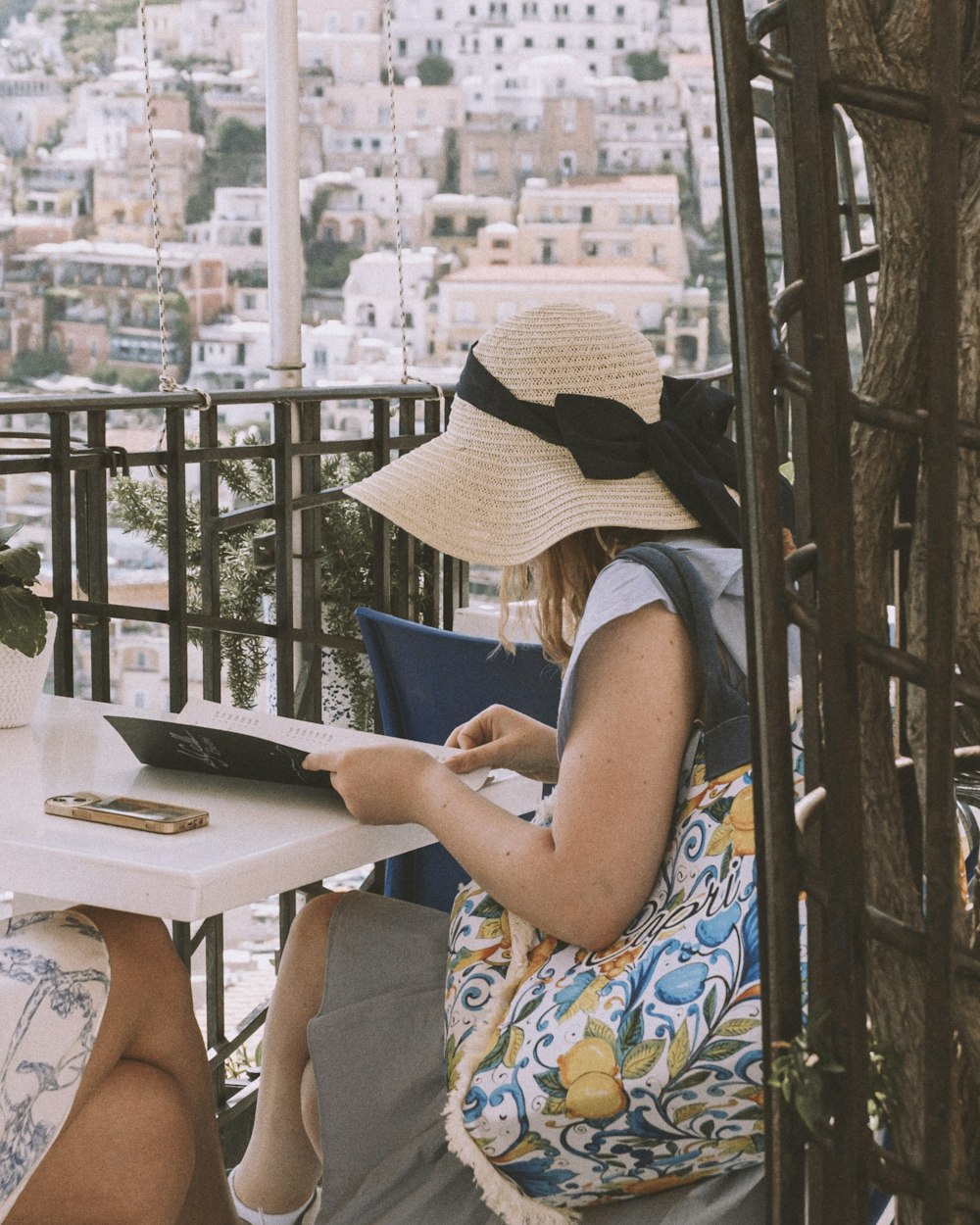 a woman sitting at a table with a laptop