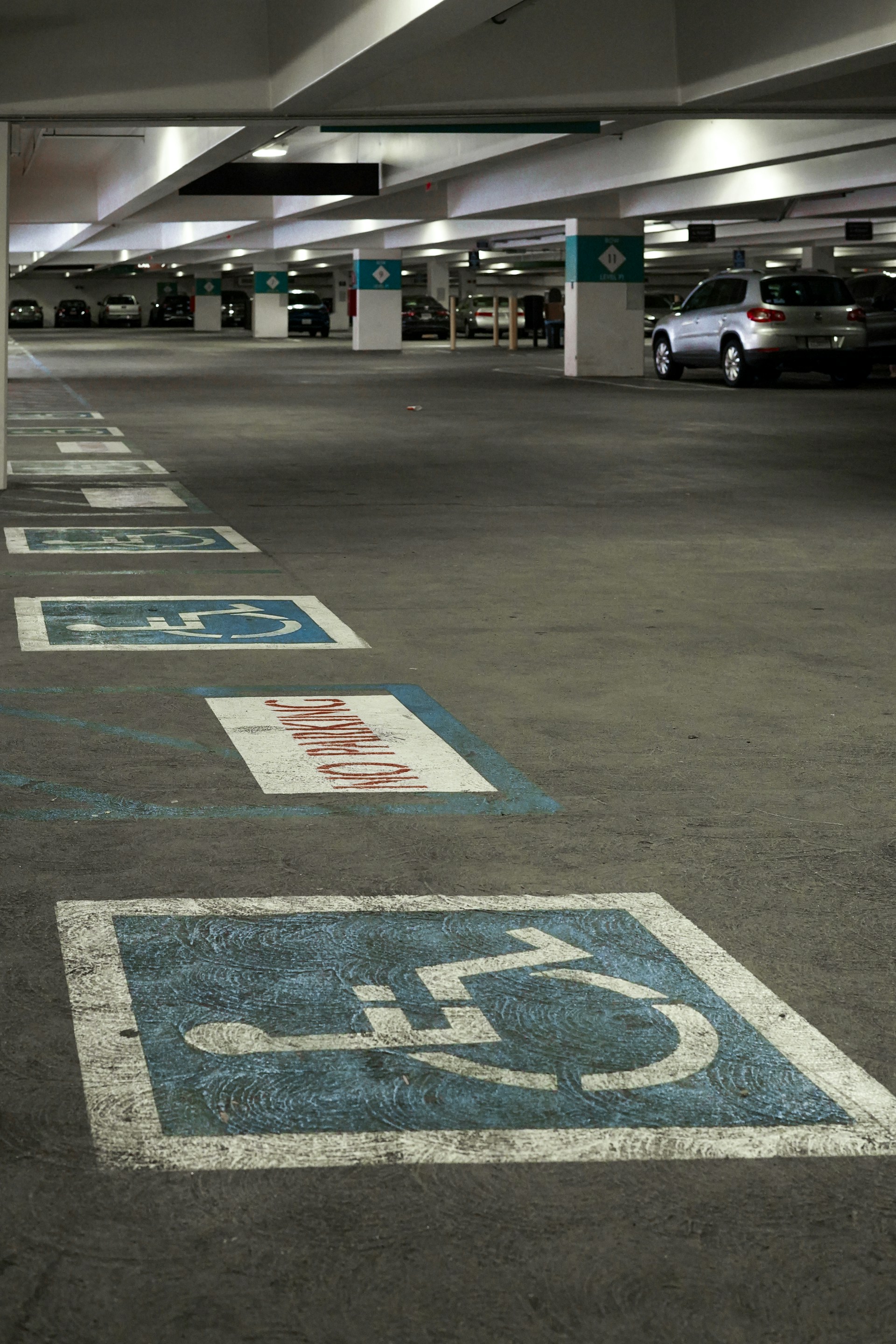 an empty parking garage with blue and white signs