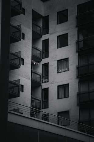 A modern apartment building with large windows and balconies.