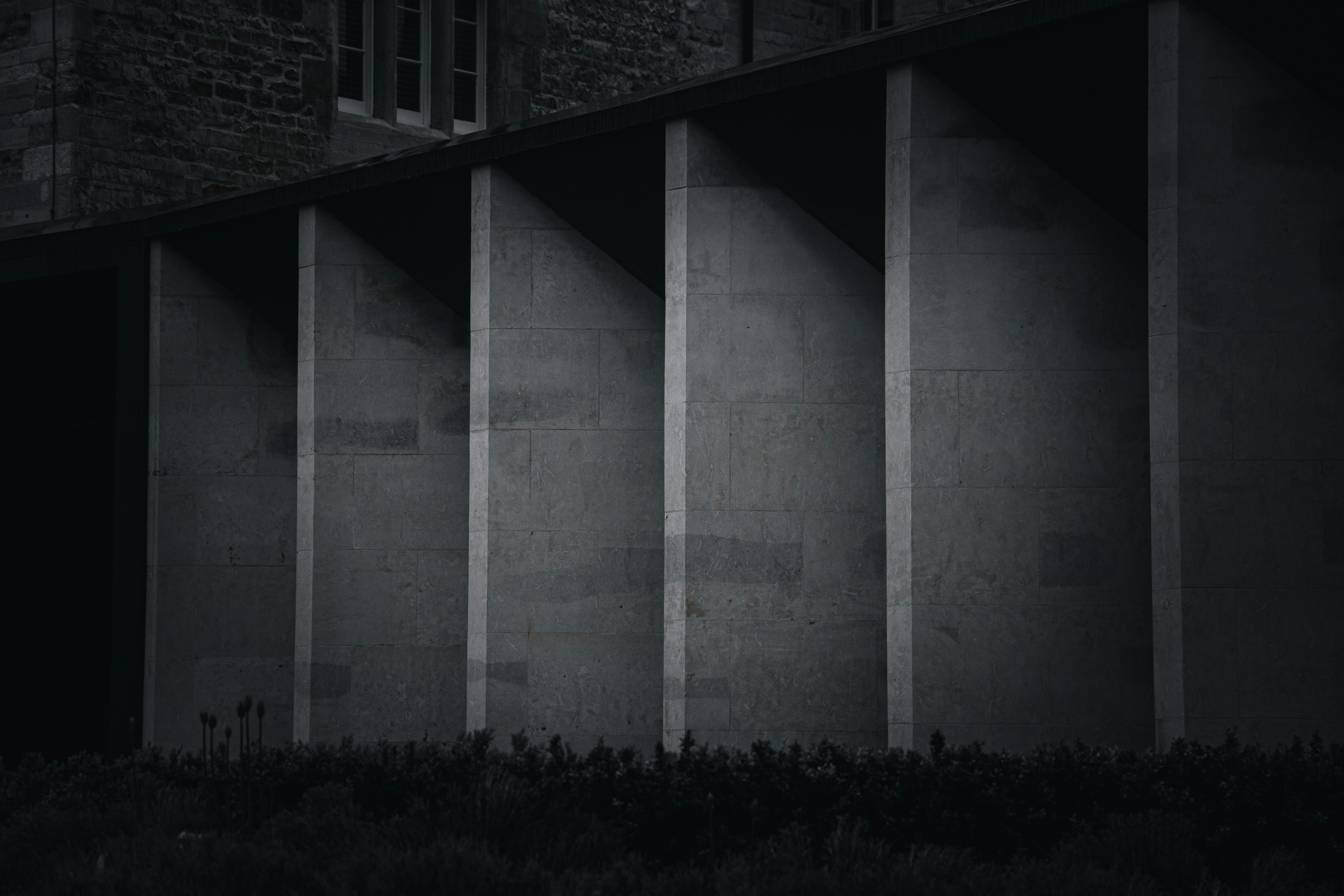 a black and white photo of a building (Photo by Jack Baxter on Unsplash)