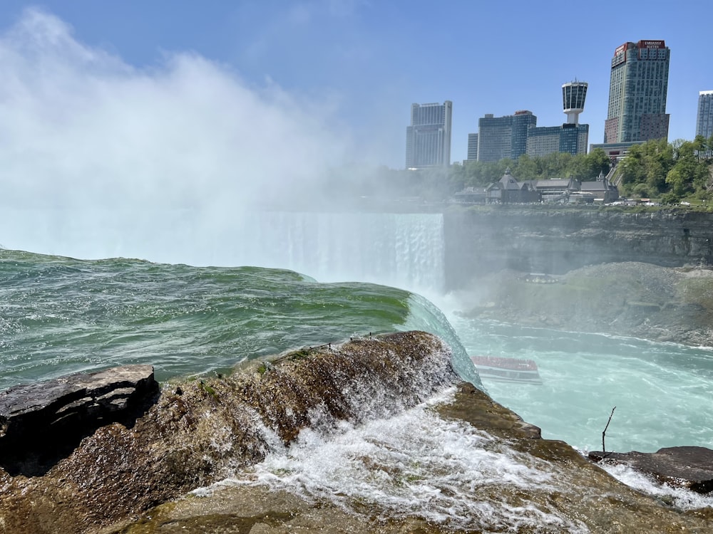 a view of the niagara falls with a city in the background