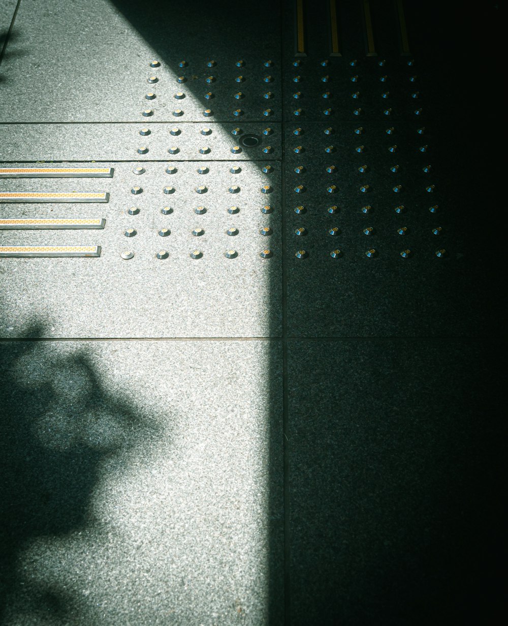 a shadow of a person walking down a sidewalk