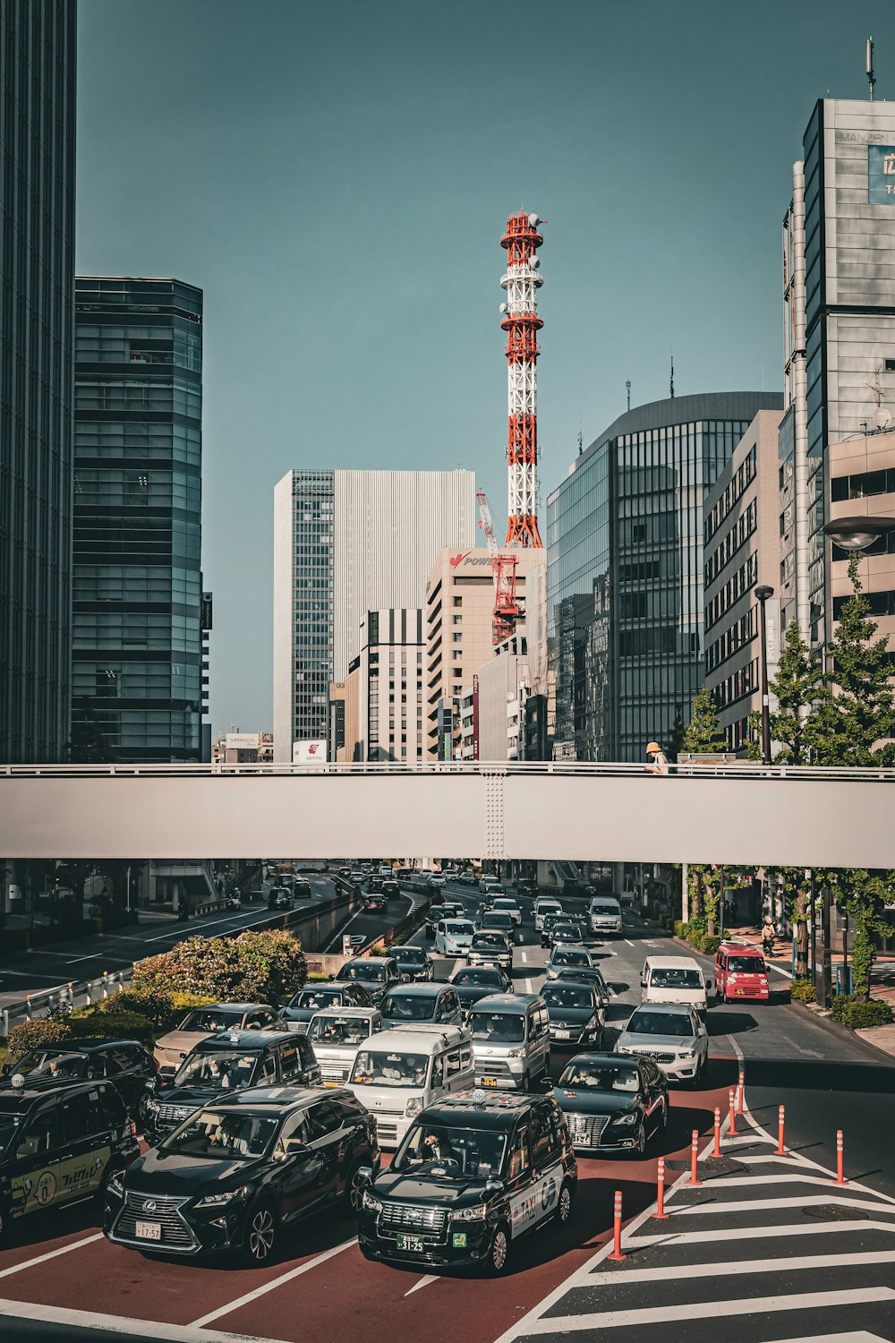 a street filled with lots of traffic next to tall buildings