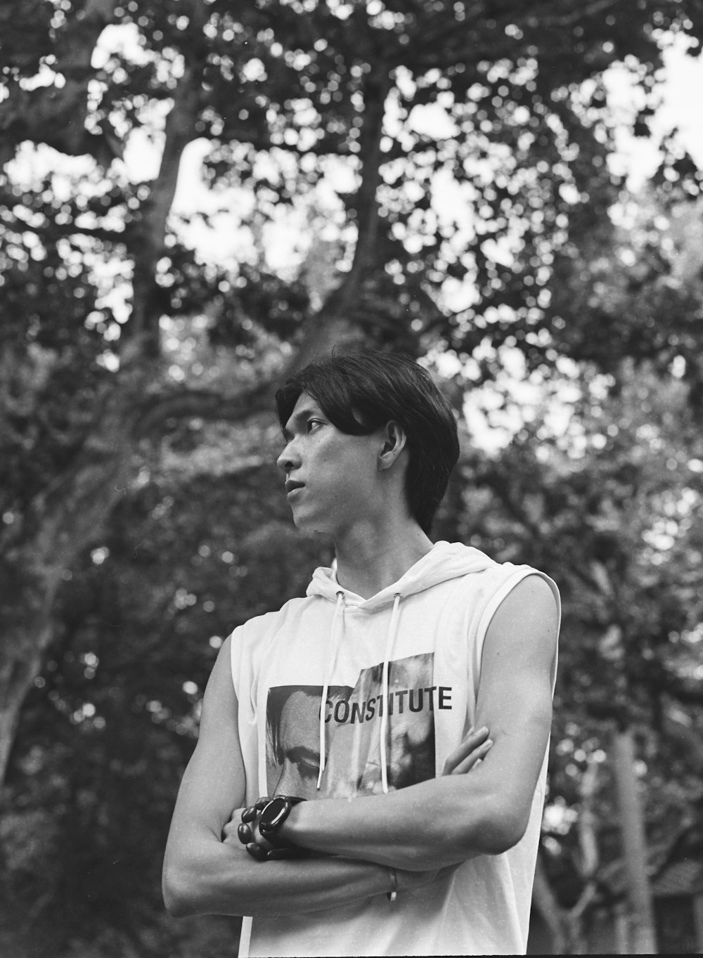 a black and white photo of a man with his arms crossed