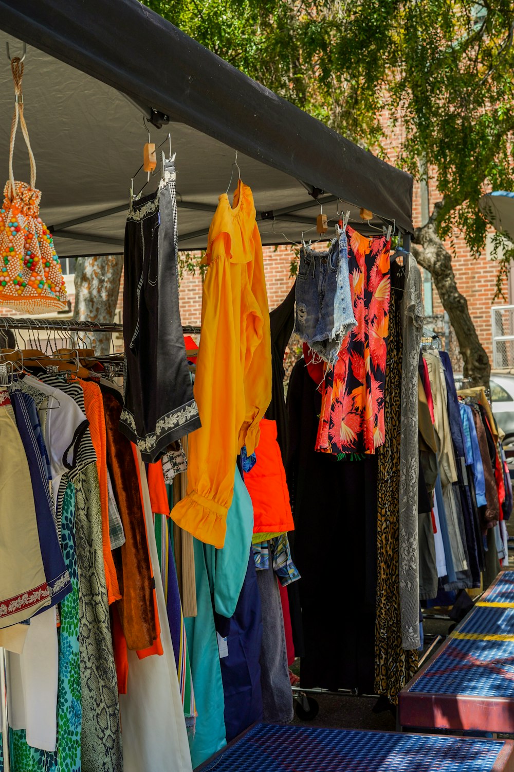 a bunch of clothes that are on a rack