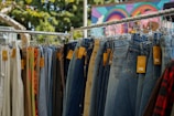 a rack of jeans hanging on a clothes line