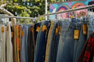 An artistic display of multiple brand tags hanging from a clothing rack.