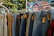 A display of various jeans and pants hanging on a rack in a bright store.