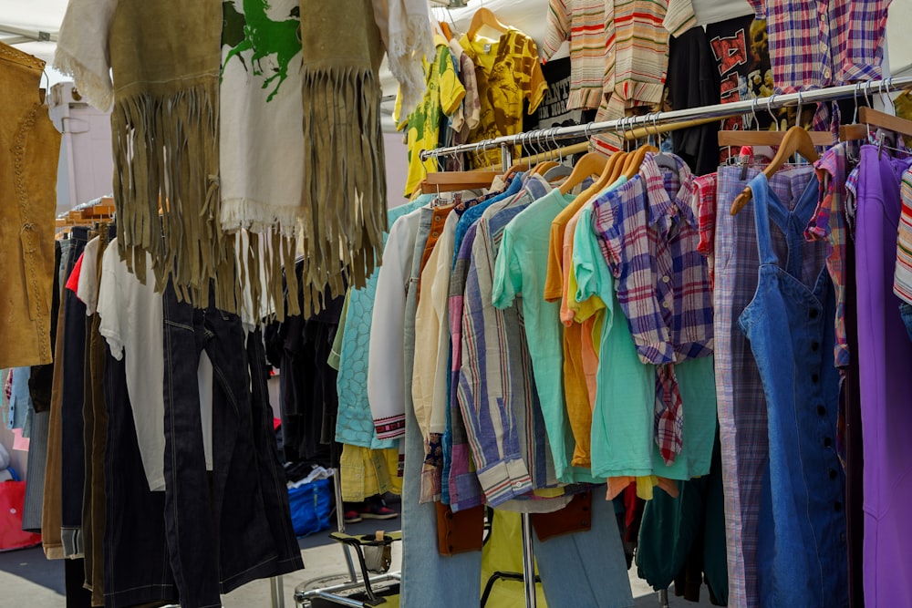 a rack of shirts and pants hanging on a clothes rack